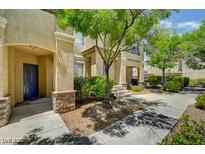 Inviting stucco home featuring desert landscaping with mature trees and bushes enhancing the curb appeal at 1713 Queen Victoria St # 104, Las Vegas, NV 89144