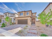 Beautiful two-story home with a modern design, attractive brick driveway, and low-maintenance desert landscaping at 244 Native Stone St, Las Vegas, NV 89138