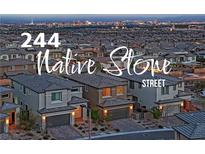Charming street view showcasing modern homes with desert landscaping and a distant city skyline at 244 Native Stone St, Las Vegas, NV 89138