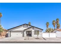 Charming single-story home featuring a two-car garage, palm trees, desert landscaping, and a white stucco facade at 4774 San Sebastian Ave, Las Vegas, NV 89121