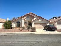 Charming single-story home with a well-manicured lawn and a two-car garage at 632 Hitchen Post Dr, Henderson, NV 89011