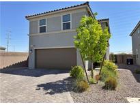Modern two-story home featuring low maintenance desert landscaping and a two-car garage at 8710 Beverly Grove Ct, Las Vegas, NV 89113