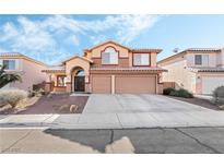 Charming two-story home with a well-manicured lawn and a spacious two-car garage, perfect for families at 9785 Gallo Dr, Las Vegas, NV 89147