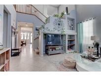 Bright living room boasts an open floor plan with a staircase and built-in shelving at 10422 Prairie Mountain Ave, Las Vegas, NV 89166