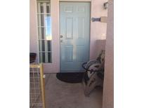 Charming entry with a light blue front door and adjacent window, leading into the home at 10525 Autumn Pine Ave # 203, Las Vegas, NV 89144