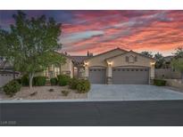 Charming single-story home featuring a stucco facade, well-manicured landscaping and a three-car garage at 11763 Kingsland Ave, Las Vegas, NV 89138