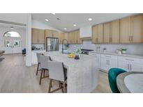A spacious kitchen featuring a marble island, stainless steel appliances, and light wood cabinets at 1594 Pontine Ct, Henderson, NV 89052