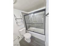 Cozy bathroom featuring a shower-tub combo with black trim and gray decorative wall and shelving for convenience at 2451 N Rainbow Blvd # 1016, Las Vegas, NV 89108