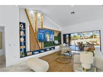 Bright living room featuring custom wall accents, sleek shelving, and an entertainment center at 2652 Golfside Dr, Las Vegas, NV 89134