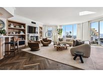 Bright living room features a fireplace, herringbone floors, city views, and stylish contemporary decor at 2857 Paradise Rd # 2203, Las Vegas, NV 89109