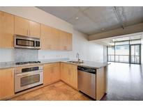 Modern kitchen features stainless steel appliances, granite countertops, and light wood cabinetry at 353 E Bonneville Ave # 503, Las Vegas, NV 89101