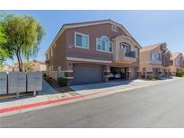 A tan-colored two-story home with a small balcony and a two-car garage at 4808 Straight Flush Dr # 103, Las Vegas, NV 89122
