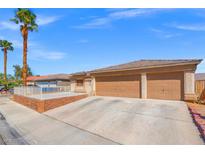 Single-story home featuring a large driveway, two-car garage, and desert landscaping at 5224 Red Vine St, North Las Vegas, NV 89031