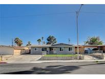Charming single-story home with a well-manicured lawn and secure chain-link fence at 5409 Holmby Ave, Las Vegas, NV 89146