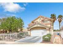 Two-story home with a red tile roof, white iron fence, arched entryway, and a well-maintained landscape at 6440 High Sierra Ave, Las Vegas, NV 89156