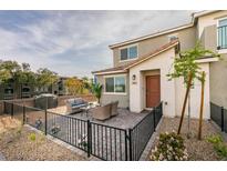 Inviting home exterior with a private, fenced patio and charming curb appeal in a well-maintained community at 6804 Sage Gold Ct, North Las Vegas, NV 89086