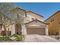 Charming two-story home with stucco exterior, two-car garage, and brick paver driveway at 7060 Seat Wall Rd, Las Vegas, NV 89148