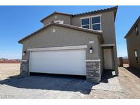 Two-story home with a neutral color palette, a two car garage, and a well-kept front yard at 9548 Hinson St, Las Vegas, NV 89139