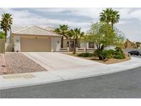 Charming single-story home with a beige exterior, well-manicured landscaping, and a two-car garage at 2212 Marble Gorge Dr, Las Vegas, NV 89117