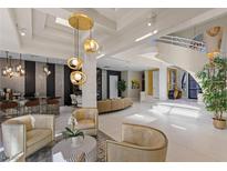 Stunning living room with unique chandelier, and modern design elements throughout at 8109 Moonstone Cir, Las Vegas, NV 89128