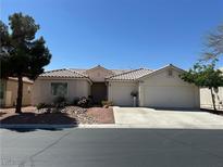 Charming single-story home featuring a neutral color, well-manicured front yard, and a spacious two-car garage at 9539 Iris Flat Ct, Las Vegas, NV 89178