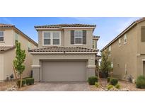 Charming two-story home with a well-manicured front yard and an attached two-car garage at 2293 Teatro Ave, Henderson, NV 89044