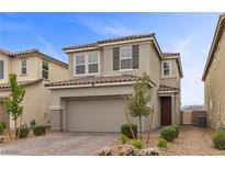 Charming two-story home featuring a two-car garage, a brown-tiled roof, and drought-resistant landscaping at 2293 Teatro Ave, Henderson, NV 89044