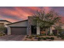 Charming single-story home with desert landscaping and a stone accent wall and two car garage at 109 Reverie Heights Ave, Henderson, NV 89011