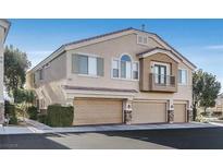 Charming townhome featuring attached garages, a private balcony, and low-maintenance landscaping at 2509 April Breeze Ln, Henderson, NV 89002
