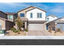Charming two-story home featuring desert landscaping, a tiled roof, and an attached two-car garage at 4368 Latitude Valley Ct, North Las Vegas, NV 89084