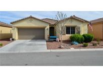 Charming single-story home with a well-manicured front yard and attached two-car garage at 4770 Lorenzo Way, Pahrump, NV 89061