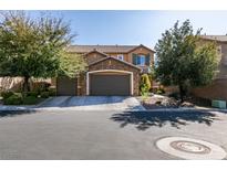 Beautiful two-story home with a three-car garage, stone accents and mature trees enhancing curb appeal at 6470 Crest Estates St, Las Vegas, NV 89131