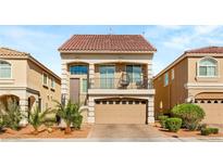 Charming two-story home features a red-tile roof, balcony, and a two-car garage with paver driveway at 8276 Sorrel St, Las Vegas, NV 89139