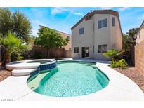 Backyard pool with attached spa, stone trim, and easy access to home's sliding glass door at 844 Binbrook Dr, Henderson, NV 89052