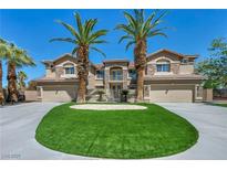Beautiful two-story home featuring a circular driveway and two majestic palm trees framing the entrance at 9504 Empire Rock St, Las Vegas, NV 89143