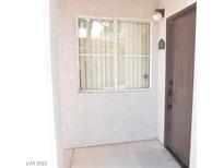 The unit entrance features neutral stucco and a window with privacy blinds at 2615 W Gary Ave # 1015, Las Vegas, NV 89123