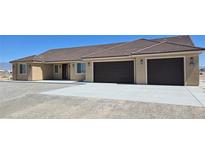 A single-story home has a tile roof, two-car garage, and desert landscaping at 3761 S Tumbleweed Ave, Pahrump, NV 89048