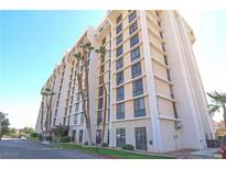 A multi-story building with classic architecture is surrounded by green space and trees, a clear blue sky at 3930 University Center Dr # 409, Las Vegas, NV 89119