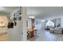 Bright living room and kitchen features modern decor, an open layout, and whitewashed wood flooring at 3930 University Center Dr # 409, Las Vegas, NV 89119