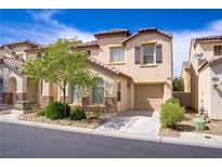 Charming two-story townhome featuring desert landscaping, a private driveway, and an attached one car garage at 4972 Groveland Ave, Las Vegas, NV 89139