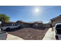 Charming single-story home featuring a low maintenance yard, neutral stucco facade and an attached two-car garage at 5135 Shimmering Peak Way, North Las Vegas, NV 89031