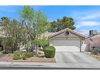 Charming single-story home with a two-car garage, landscaped front yard and inviting curb appeal at 1658 Autumn Rust Dr, Las Vegas, NV 89119