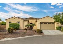 Charming single-story home featuring a tan exterior, manicured landscaping, and a two-car garage at 5300 E La Terra Ave, Pahrump, NV 89061