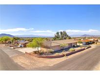Charming single-story home featuring desert landscaping and mountain views against a clear blue sky at 2251 Thoroughbred Rd, Henderson, NV 89002