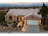 Charming single-story home with a tile roof, two-car garage, and stunning city views in the background at 2728 Faiss Dr, Las Vegas, NV 89134