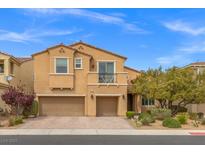 Charming two-story home featuring stucco siding, a balcony, three-car garage, and neatly landscaped yard at 4212 Hawks Glide Ave, North Las Vegas, NV 89084