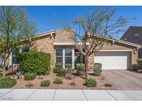 Charming single-story home featuring a stone facade, tile roof, desert landscaping, and an attached two-car garage at 8440 Footpath St, Las Vegas, NV 89166