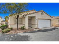 Charming single-story home with a two-car garage, mature tree, and neutral-toned stucco exterior at 5114 Mascaro Dr, Las Vegas, NV 89122