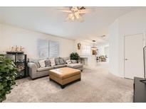 Cozy living room with a neutral color palette, comfortable sectional sofa, and plush ottoman at 5114 Mascaro Dr, Las Vegas, NV 89122