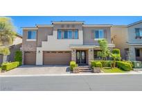 Charming two-story home with a three-car garage and beautifully landscaped front yard at 8303 Saddleback Ledge Ave, Las Vegas, NV 89147